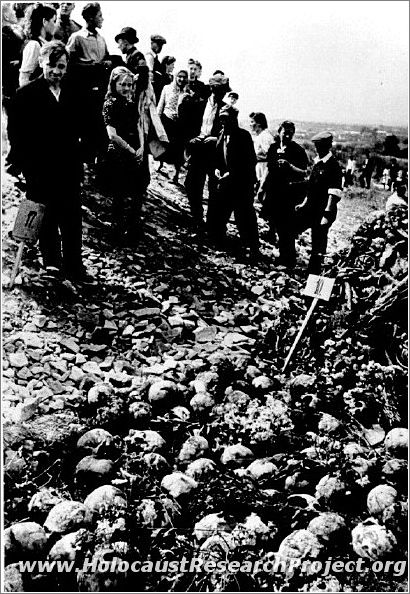 Polish civilians view the rows of human skulls at Majdanek
